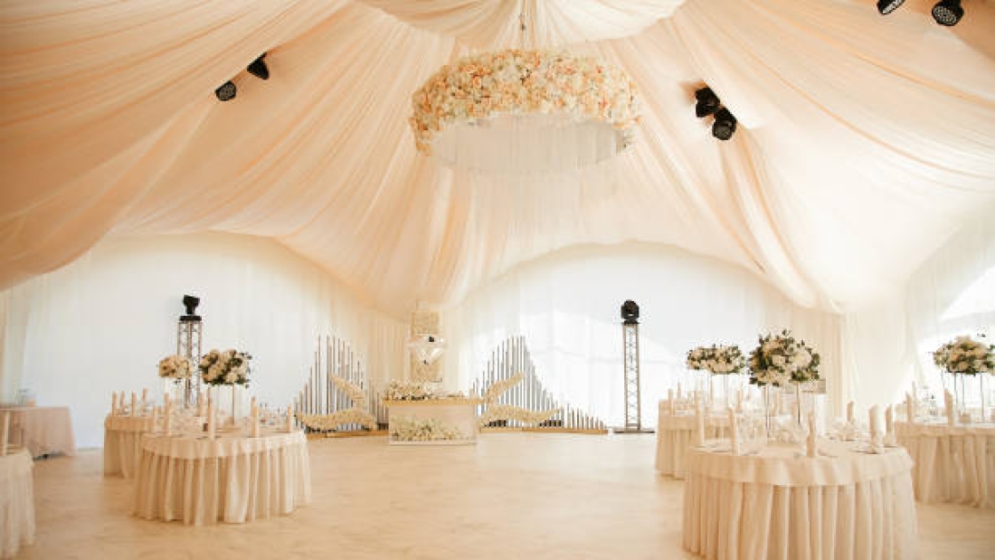 Luxurious high tent decorated for wedding celebration.